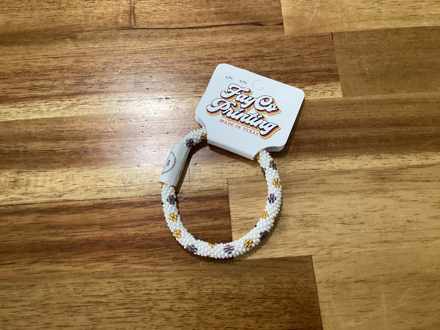 purple, gold, and white Beaded bracelet