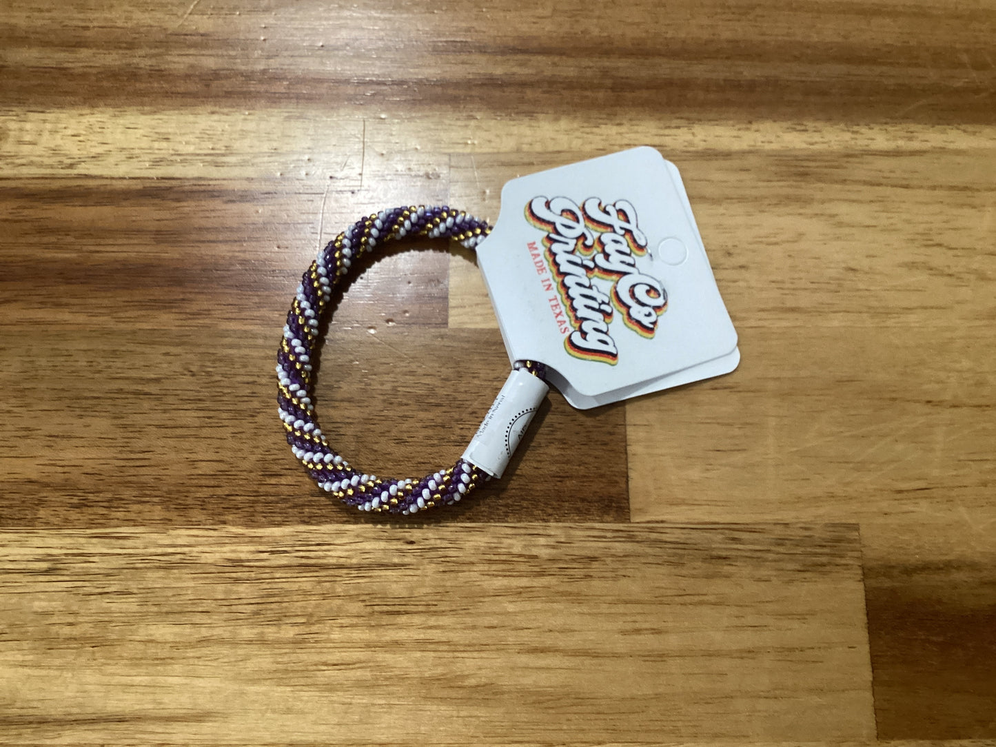 purple, gold, and white Beaded bracelet