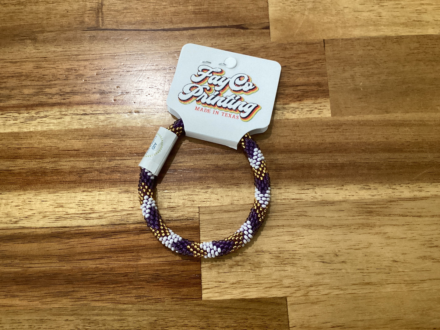 purple, gold, and white Beaded bracelet