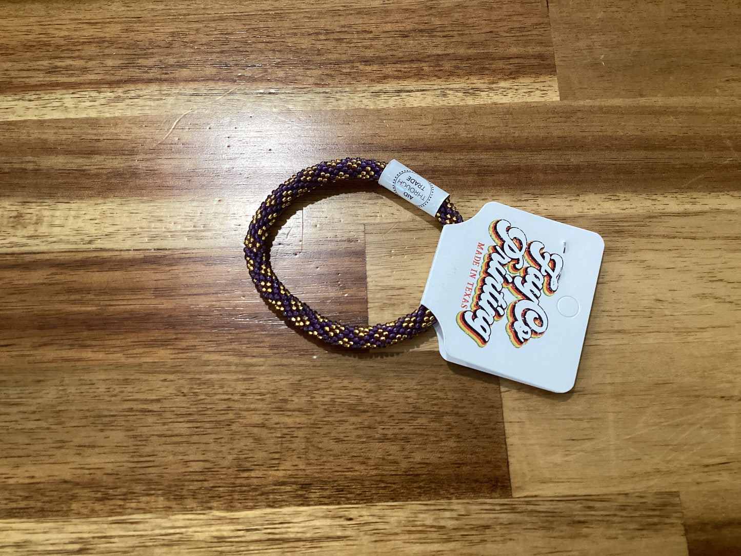purple, gold, and white Beaded bracelet