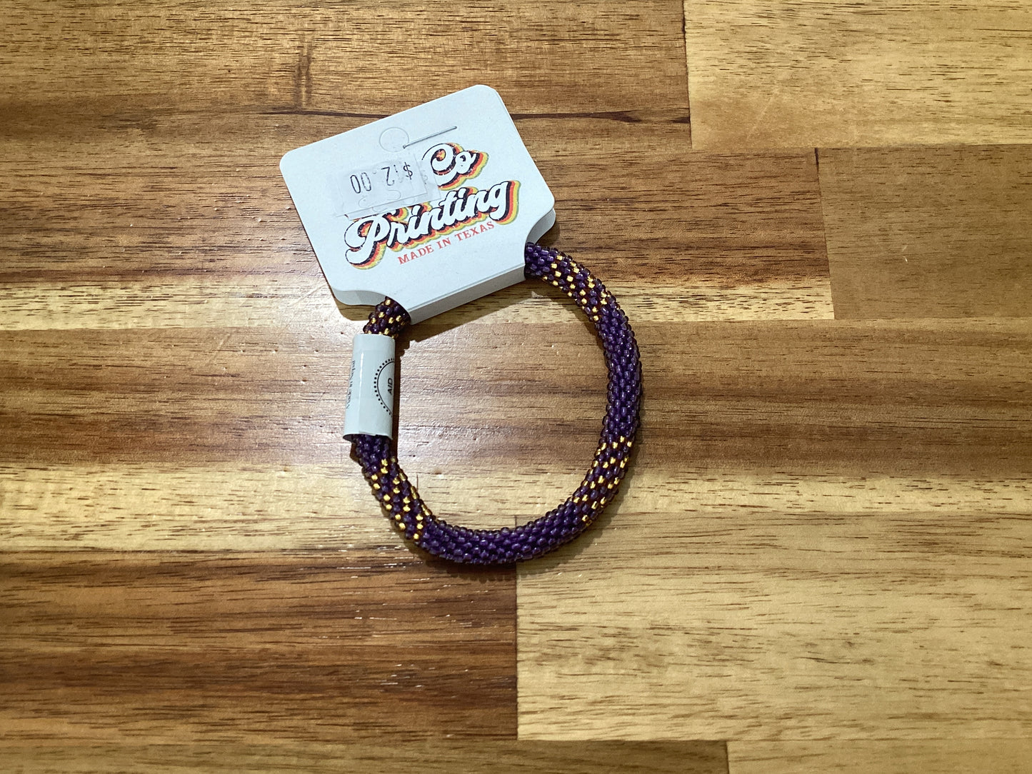 purple, gold, and white Beaded bracelet